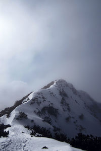 Scenic view of snow covered mountains against sky