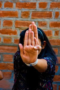 Teenage girl covering face with hand