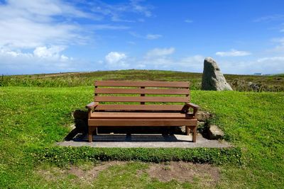 Scenic view of grassy field against sky