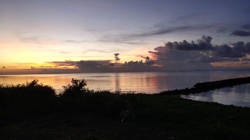 Scenic view of lake against sky during sunset