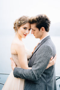 Side view of young couple standing outdoors