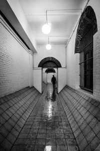 Man walking in illuminated corridor