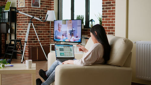 Woman using laptop at home