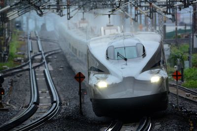 Shinkansen n700s passing through maibara station in the rain