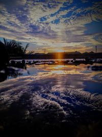 Scenic view of lake against sky during winter