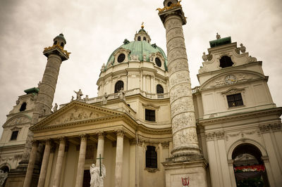 Low angle view of historical building against cloudy sky