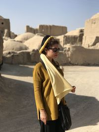 Portrait of young woman standing on road