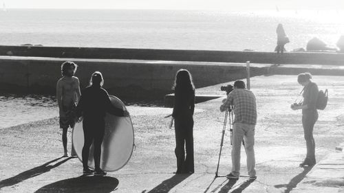 Rear view of people looking at sea