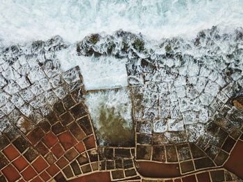 High angle view of sea waves splashing on promenade