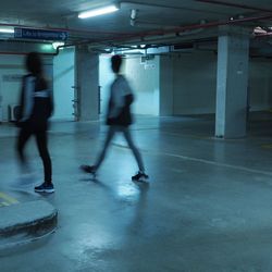 Blurred motion of woman in illuminated room
