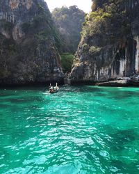 Scenic view of sea by mountains