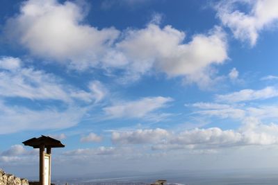 Low angle view of windmill against blue sky