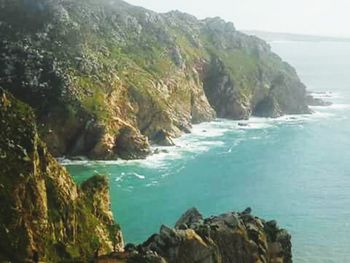 Scenic view of sea with rocks in background