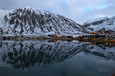 Scenic view of lake and snowcapped mountains against sky