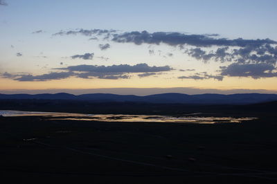 Scenic view of silhouette landscape against sky during sunset