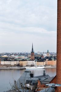 High angle view of river by buildings against sky