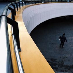 High angle view of man walking on staircase