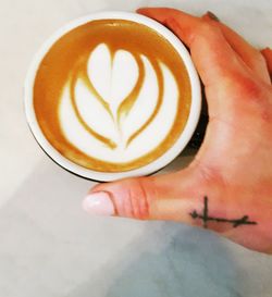 Close-up of hand holding coffee cup