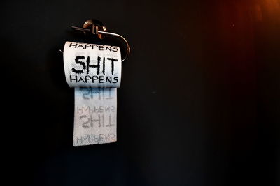 Close-up of information sign against black background