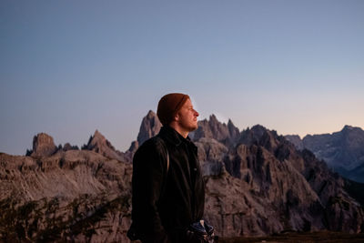 Rear view of man standing against mountain