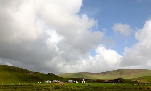 Scenic view of green landscape against sky