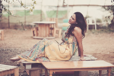 Smiling woman sitting on table