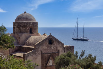 View of building by sea against sky