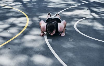 Young man exercising on basketball court