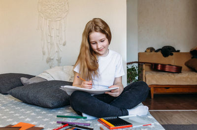 Portrait of young woman using digital tablet at home