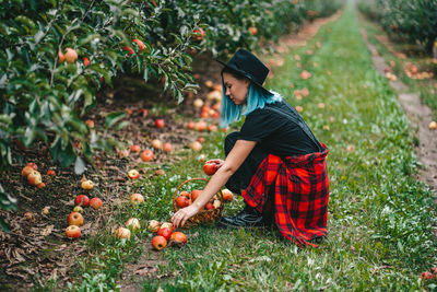 Full length of girl eating fruit on field