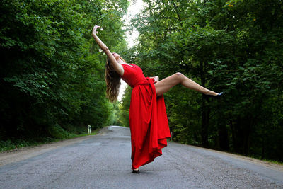 Rear view of woman standing by road