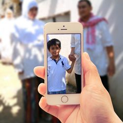 Portrait of young woman holding mobile phone