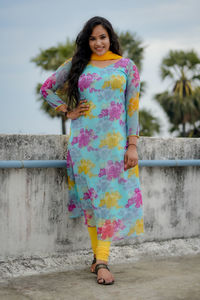 Portrait of young woman standing against wall