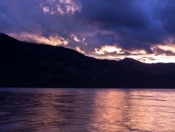 Scenic view of calm lake against mountain range