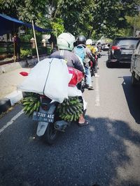 Rear view of people walking on road