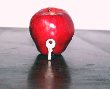 Close-up of red apple on table