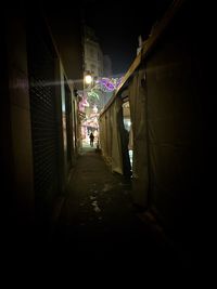 Narrow alley in city at night