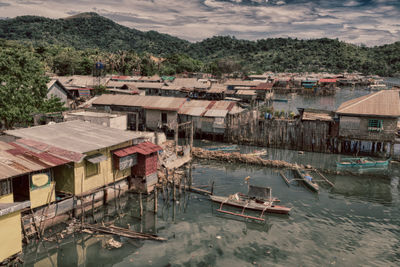 High angle view of houses by river and buildings