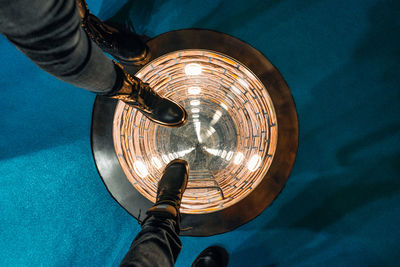 Shoes stepping on round illuminated well