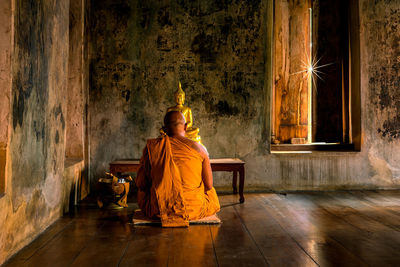 Rear view of man sitting in temple