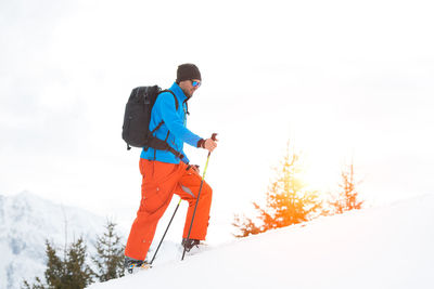 Full length of man skiing on snow covered field