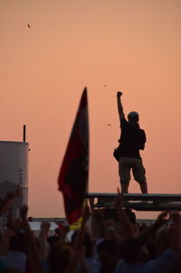 Woman photographing at sunset