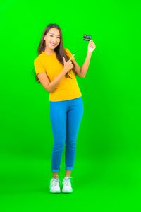 Full length portrait of a smiling young woman