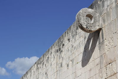 Low angle view of old building against blue sky