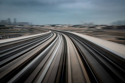 High angle view of railroad tracks in city against sky