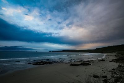 Scenic view of beach against sky during sunset