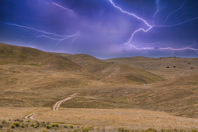 Scenic view of lightning on mountain against sky