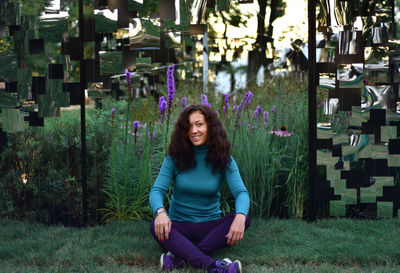 Portrait of smiling woman sitting at park