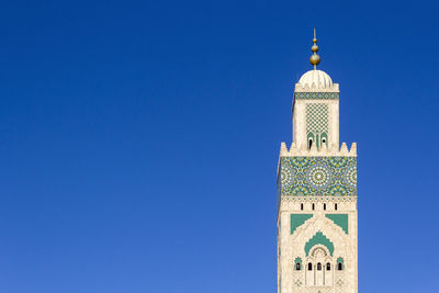 View of mosque against clear blue sky