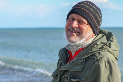 Portrait of man in sea against sky